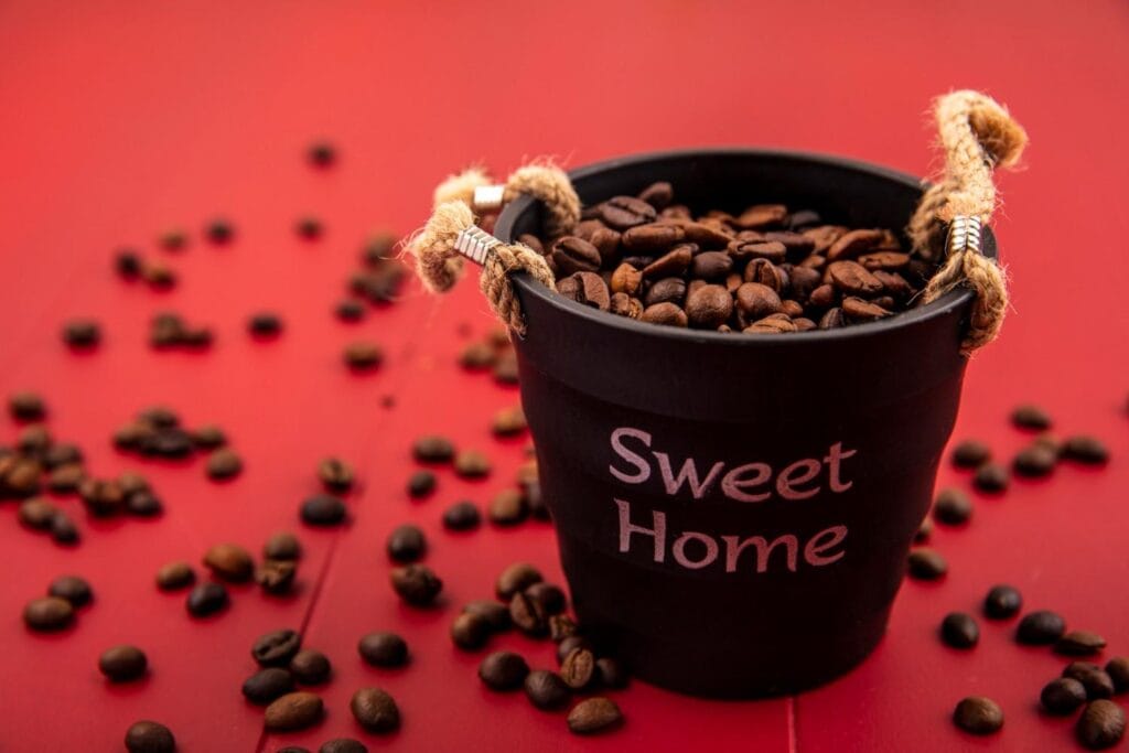 sweet home bucket with coffee beans on red background