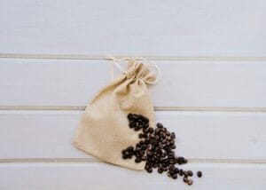 A jute bag with coffee beans indication how long are coffee beans good for opened