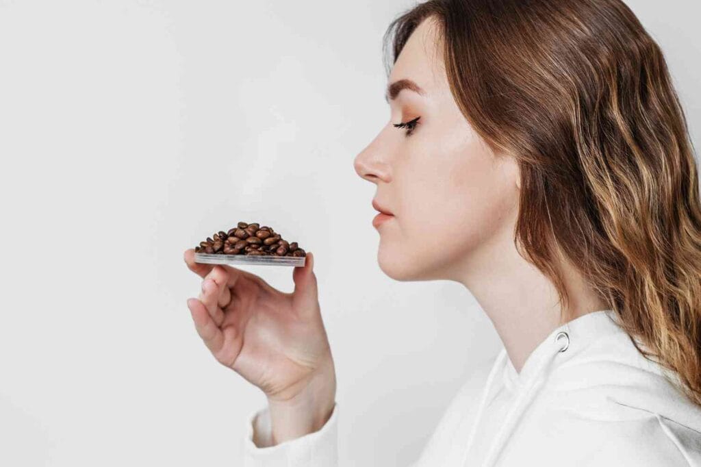 girl smelling coffee beans