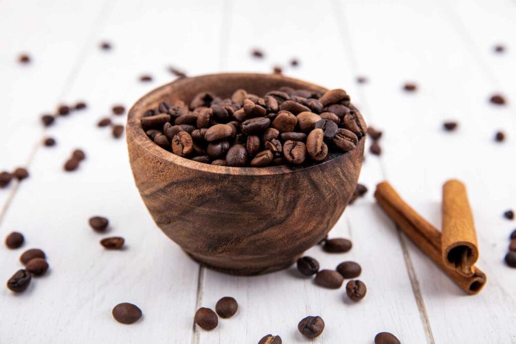 coffee beans in wooden bowl and cineman on floor
